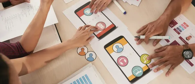Group of people choosing between different icons for a mobile app
